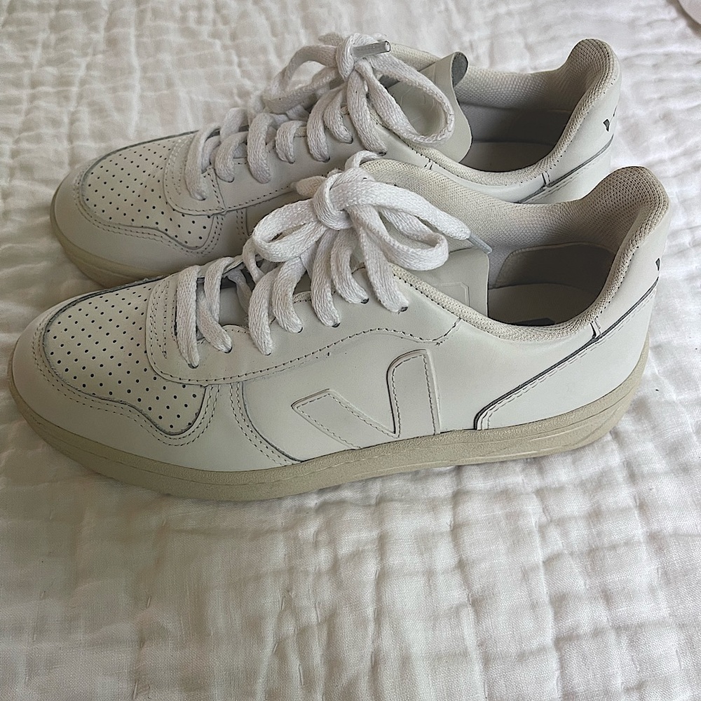 All white leather lace up sneakers by VEJA